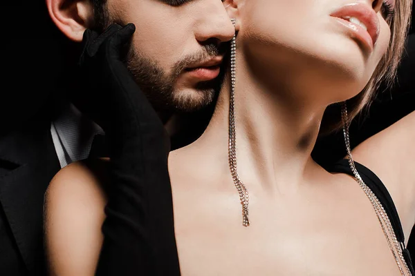 Cropped view of man near young woman isolated on black — Stock Photo