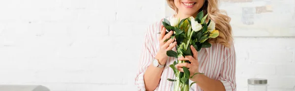 Panoramic shot of happy woman holding bouquet of tulips — Stock Photo