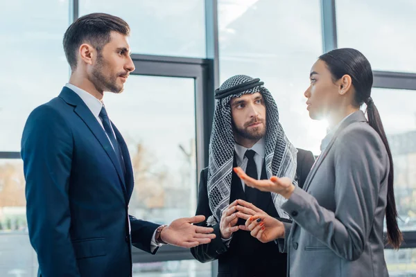 Multicultural businesspeople discussing contract on meeting with translator in office — Stock Photo