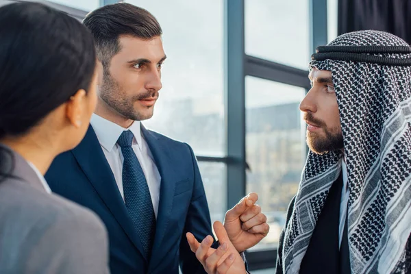 Multicultural businesspeople discussing work on meeting with translator in office — Stock Photo