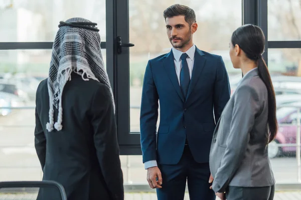 Multicultural business partners on meeting with translator in office — Stock Photo