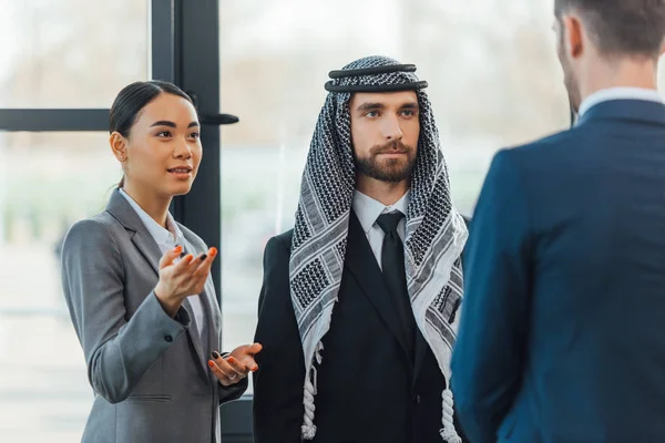 Multiethnic business partners on meeting with translator in office — Stock Photo