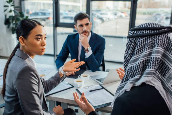 Multicultural businesspeople discussing contract on meeting with translator in office — Stock Photo