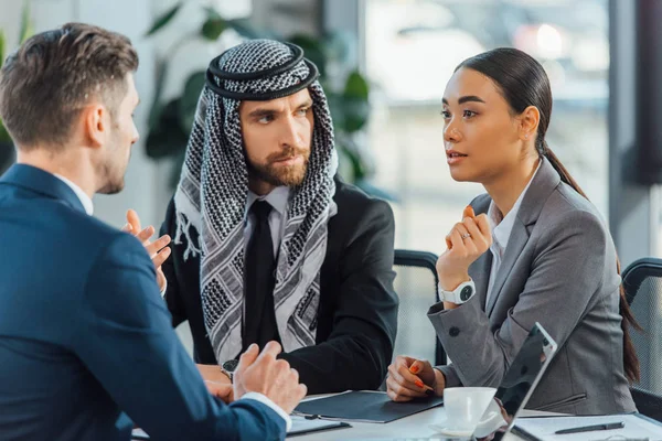 Multicultural business partners talking on meeting with translator in office — Stock Photo