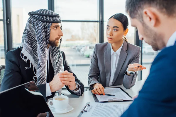 Multiethnic business partners on meeting with translator in office — Stock Photo