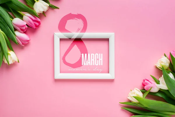 Top view of white frame with tulips on pink background, 8 march illustration — Stock Photo