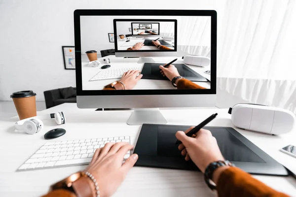 Cropped view of 3d artist using graphics tablet and computer near digital devices on table — Stock Photo