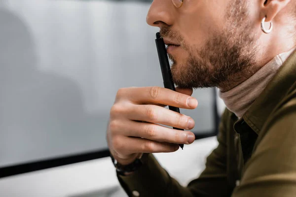 Cropped view of 3d artist holding stylus of graphics tablet near computer monitor on grey background — Stock Photo