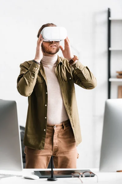 3d artist using vr headset while working near computers and graphics tablet on table in office — Stock Photo