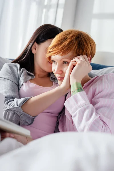 Focus selettivo della donna che tiene la mano della ragazza sul letto — Foto stock