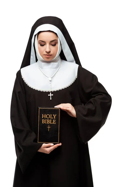 Beautiful nun holding holy bible isolated on white — Stock Photo