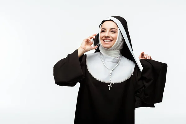 Cheerful nun talking on smartphone isolated on white — Stock Photo