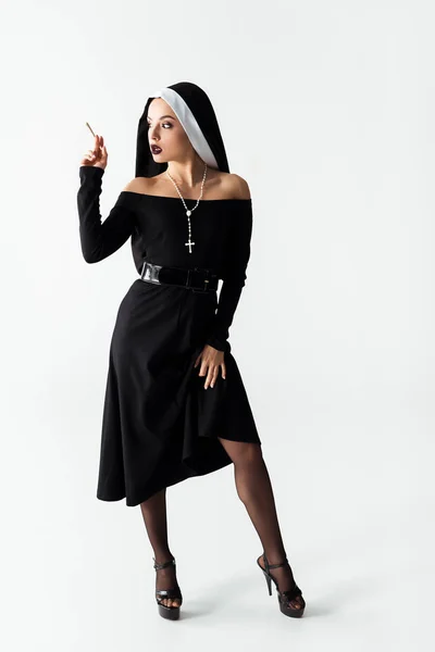 Passionate nun with marijuana joint on grey — Stock Photo