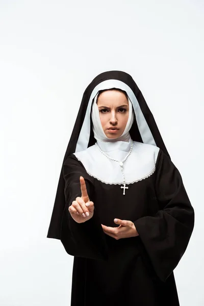 Serious nun in black clothing showing warning sign, isolated on white — Stock Photo