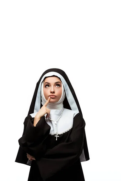 Thoughtful nun in black clothing looking up, isolated on white — Stock Photo