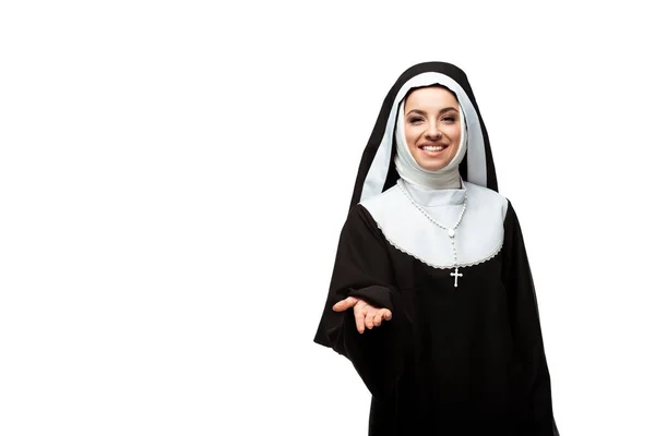 Beautiful smiling nun in black clothing reaches out hand, isolated on white — Stock Photo