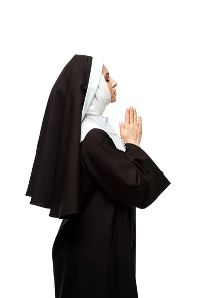 Beautiful nun praying with closed eyes and hands together isolated on white — Stock Photo