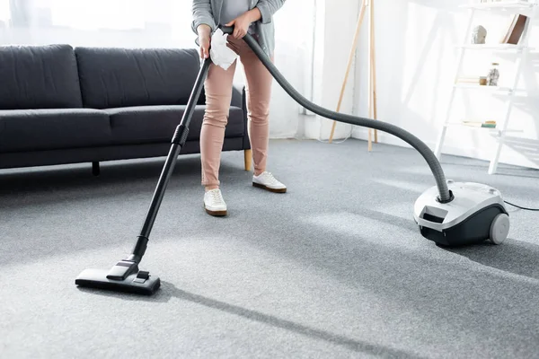 Cropped view of allergic woman holding vacuum cleaner and napkin — Stock Photo