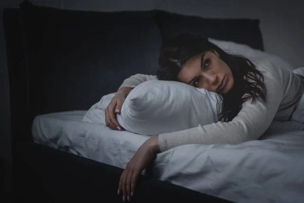 Awake woman with insomnia lying on pillow at night — Stock Photo