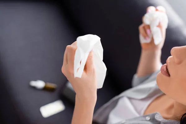 Cropped view of allergic woman with running nose holding tissues — Stock Photo