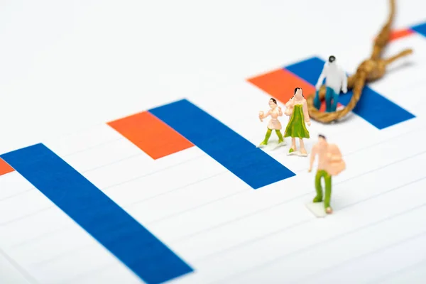 High angle view of plastic people figures near noose with knot on charts isolated on white, equality concept — Stock Photo