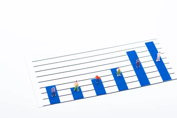 High angle view of people figures on surface of blue graphs isolated on white, concept of equality — Stock Photo