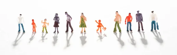 Panoramic shot of people figures on white surface with shadow — Stock Photo