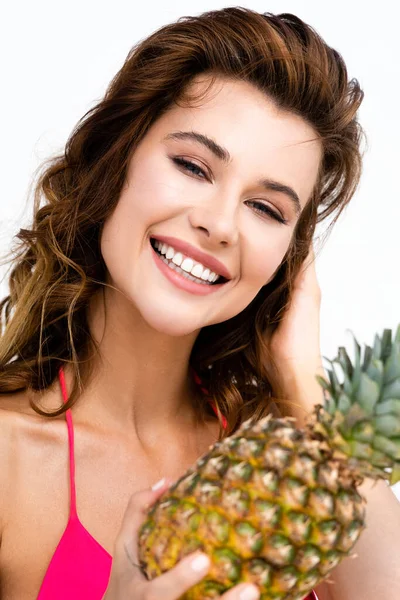 Smiling beautiful sexy girl in swimsuit with pineapple isolated on white — Stock Photo