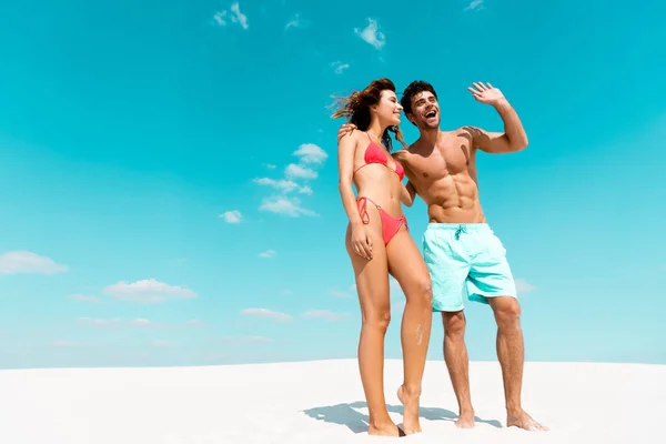 Happy young couple together on sandy beach — Stock Photo