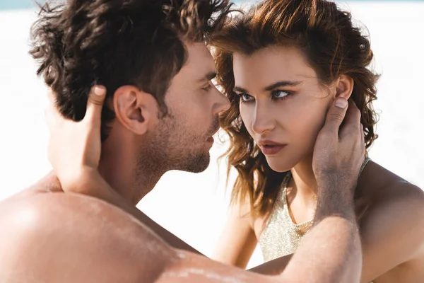 Passionate sexy young couple looking at each other on beach — Stock Photo