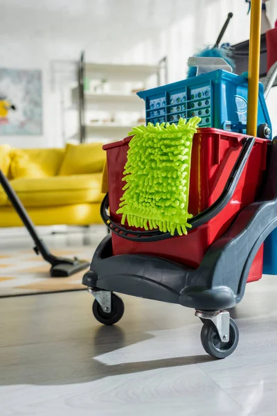 Selective focus of cleaning trolley with household in modern living room — Stock Photo