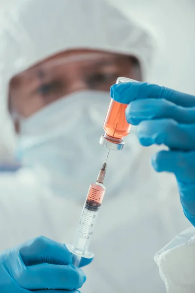Orientation sélective du biochimiste prenant des médicaments avec une seringue en laboratoire — Photo de stock