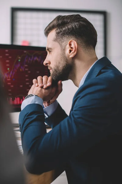 Selective focus of computer systems analyst looking at charts on computer monitor — Stock Photo