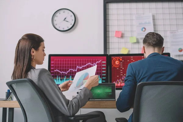 Data analysts working with computers and graphs in office — Stock Photo