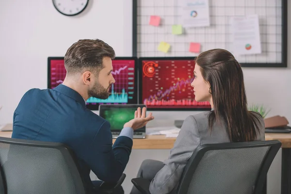 Back view of analysts planning protection for computer systems in office — Stock Photo