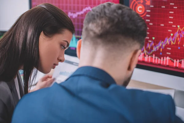 Enfoque selectivo de los analistas de datos que trabajan con gráficos y computadoras en la mesa en la oficina - foto de stock