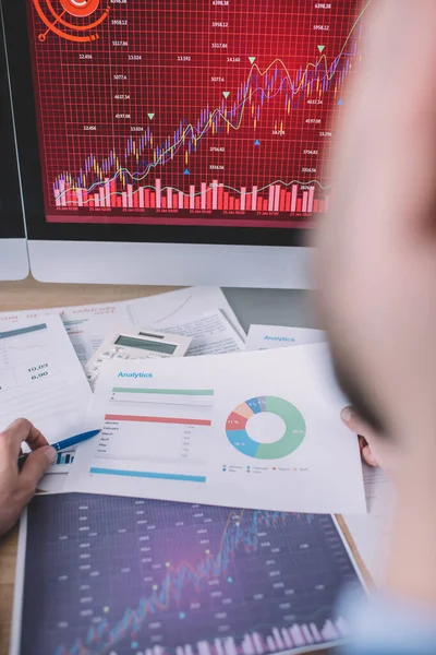 Selective focus of information security analyst working with graphs and computers at table — Stock Photo