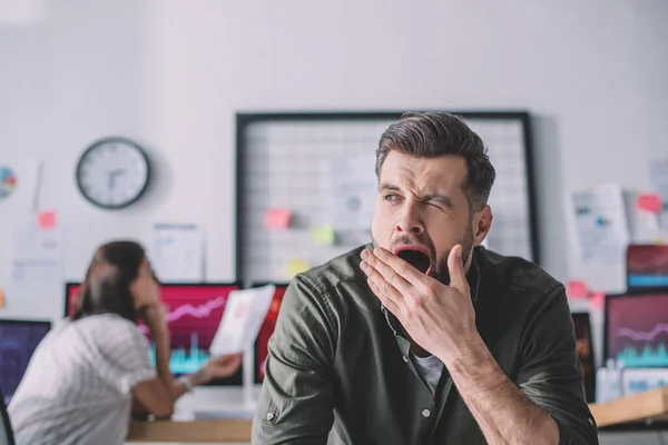 Selective focus of data analyst yawning in office — Stock Photo