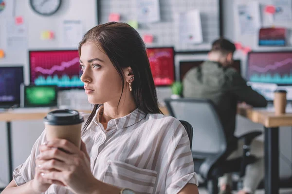 Data analyst holding coffee to go while colleague working in office — Stock Photo
