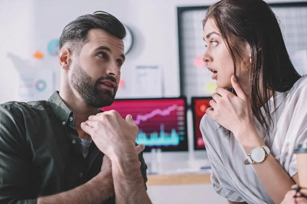 Information security analyst talking to surprised colleague with coffee to go in office — Stock Photo