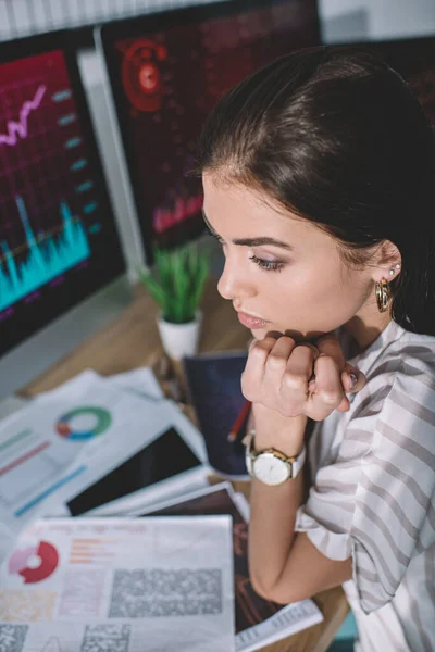 Selective focus of information security analyst sitting at table with papers and computers — Stock Photo