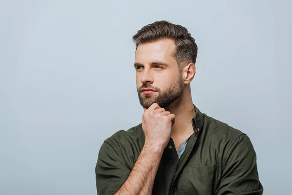Confident man with hand near chin looking away isolated on grey — Stock Photo