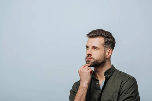 Serious man looking away isolated on grey with copy space — Stock Photo