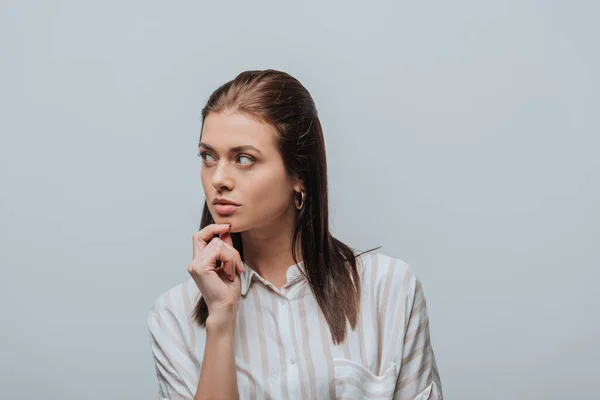 Dreamy girl looking away isolated on grey — Stock Photo