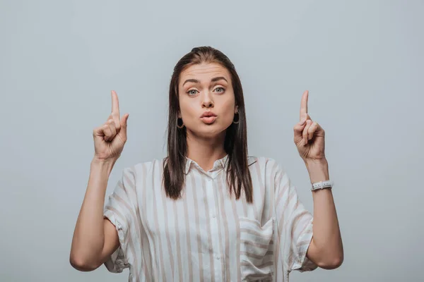 Beautiful girl pointing with fingers isolated on grey — Stock Photo