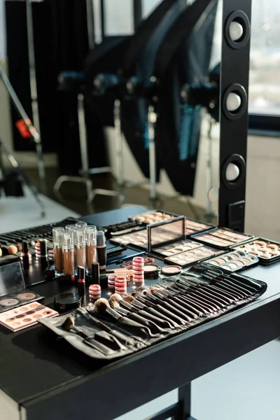 Conjunto de cepillo de maquillaje cerca de cosméticos decorativos y espejo - foto de stock