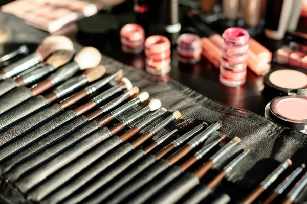 Selective focus of makeup brush set near lip balms — Stock Photo