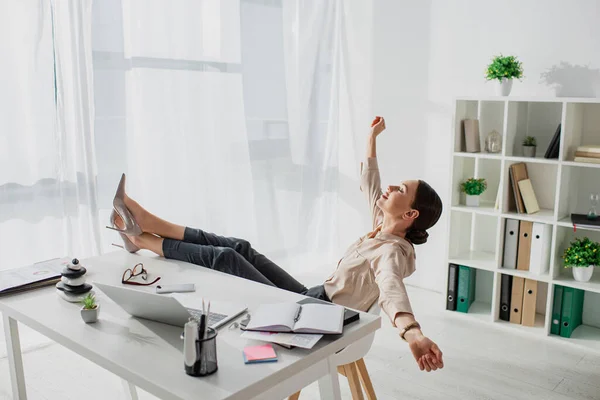 Joven mujer de negocios postergando en el lugar de trabajo en la oficina - foto de stock