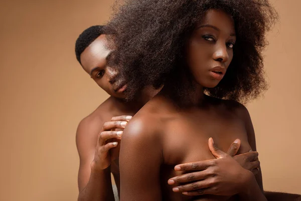 Sexy naked african american couple posing on beige — Stock Photo