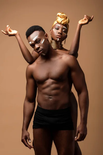 Naked tribal afro couple posing isolated on beige — Stock Photo